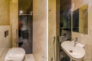 a bathroom with a toilet and a sink and a shower at FabHotel Lemon Grass - Assi Ghat in Varanasi +20 photos