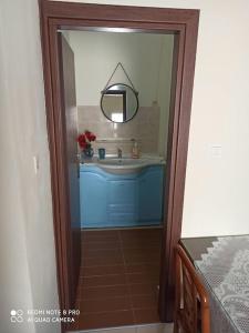 a bathroom with a sink and a mirror at Big family house (detached) in Néa Péramos