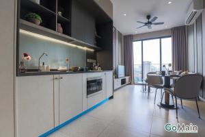 a kitchen with a table and a dining room at 2Br Family Suite MILLERZ SQUARE // KL & Free Parking in Kuala Lumpur