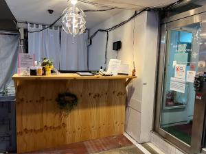 a wooden counter in a store with a window at Hostel Korea - Original in Seoul