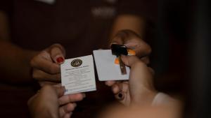 a person holding a piece of paper with a lighter at Monsoon Bassac Hotel in Phnom Penh