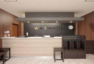 a beedia hotel lobby with a reception desk and a bar at A&Bee HOTEL in Oita