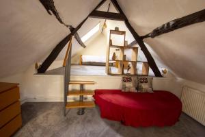 a bedroom with a bed in a attic at La Petite Maison 64 rue Arthur Lamendin in Carvin