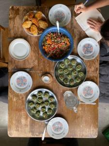 a table topped with bowls and plates of food at Eco family guest house in Mlashe