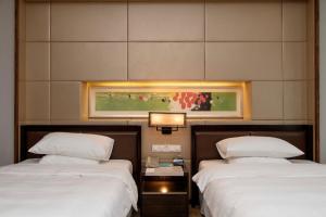 a room with two beds and a painting on the wall at Sheraton Grand Shanghai Pudong Hotel & Residences in Shanghai +60 photos