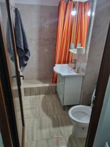 a bathroom with a toilet and a sink and a shower at Rozelor in Mangalia +10 photos