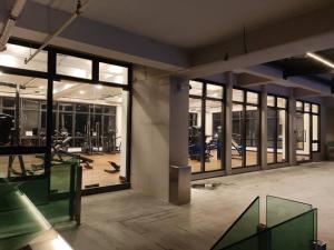 梳邦再也的住宿－The Grand SS15 2BRs Infinity Pool 200Mbps WiFi，一个带大型玻璃窗的健身房和一个带健身器材的健身房