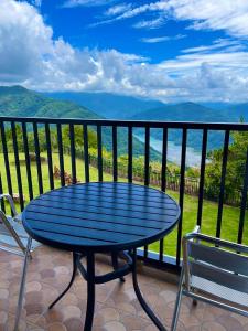 a blue table and chairs on a balcony with a view at Junyi Landscape Villa in Renai