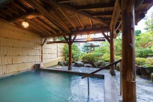 a swimming pool in a japanese garden at Yuyado Unzen Shinyu in Unzen