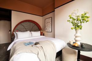 a hotel room with a bed and a table at Jan Luyken Amsterdam in Amsterdam