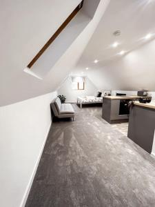 a white room with a couch and a table at Aviary Lodge in Hurn