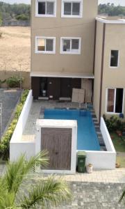 a house with a swimming pool in front of it at Beach Dreamz Villa 2 BHK Near Pondy and Auroville in Marakkānam