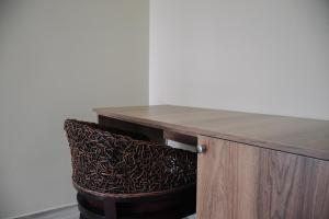 a wooden desk with a chair underneath it at Scorpio Hotel Gonio in Gonio