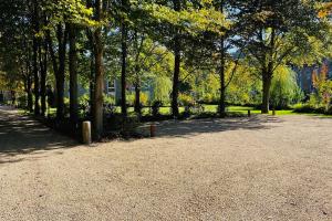a park with a lot of trees and a sidewalk at Jacuzzi - BBq - Jardin - Garden Lodge - Le Tulipier in Olne
