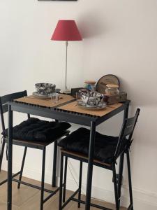 a table with two chairs and a lamp on it at Studio Oustaou à Château Gombert in Marseille