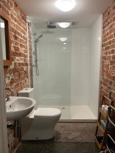 a bathroom with a shower and a toilet and a sink at Lumeah - Servant Quarters in Hobart
