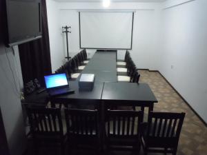 uma sala de conferências com uma mesa e um computador portátil em Cabana Transalpina em Ranca