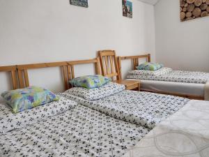 a room with three beds in a room at Satori in Władysławowo