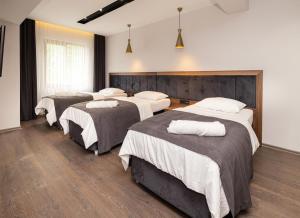A bed or beds in a room at Türkler Suite Hotel