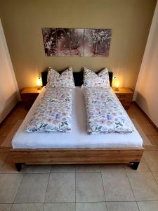 a bed in a room with two pillows on it at Gartnerhof in Plaus