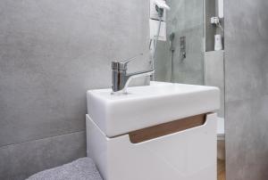 a bathroom with a white sink and a mirror at Apartament Nowy Świat 2 in Gliwice +22 photos