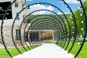 a metal archway leading to a building at Vega resort Restaurant & Lodge in Orşova