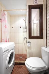 a bathroom with a washing machine and a toilet at Green Life Sozopol ~ Cozy Studio in Sozopol