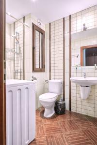 a bathroom with a toilet and a sink and a tub at Green Life Sozopol ~ Cozy Studio in Sozopol