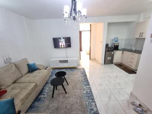 a living room with a couch and a table at Lakira Nita's place in Nairobi