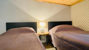 A bed or beds in a room at Vache Hotel