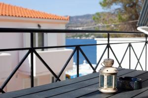 a glass jar sitting on a table on a balcony at Hara's Studio in Perdika