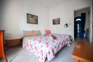 a bedroom with a bed and a table in it at Hara's Studio in Perdika