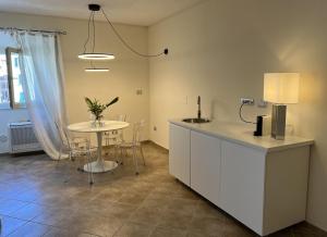 a kitchen with a table and a white counter top at La Suite di Chiara in Livorno