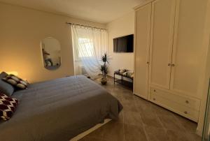 a bedroom with a bed and a dresser and a mirror at La Suite di Chiara in Livorno