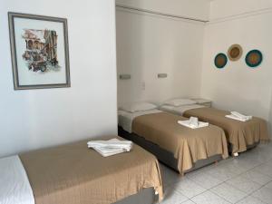 Postel nebo postele na pokoji v ubytování Louiza Hotel