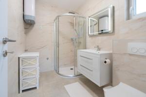 a bathroom with a shower and a toilet and a sink at Number One Apartments in Vir +69 photos