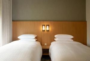 two beds sitting next to each other in a room at Four Points by Sheraton Seoul, Guro in Seoul