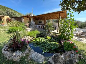 a garden with a pond in the yard at Varias Art House in Kallirákhi