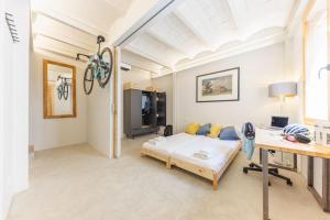 a room with a bed and a desk in it at Bravissimo Canigó, Spacious and with large terrace in Girona