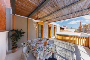 a patio with a table and chairs on a balcony at Bravissimo Canigó, Spacious and with large terrace in Girona