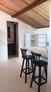 a kitchen with a table and two chairs at Casa Serena in Atins