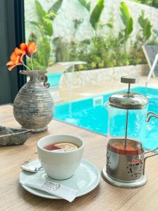 a table with a cup of coffee and a tea pot at ECHINUS HOTELS in Lara