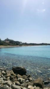 a group of rocks on the shore of a body of water at Paraiso Sardo 1 in Villasimius