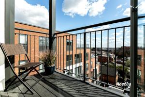 a balcony with a chair and a view of a city at Vanburgh Court Apartments in Slough