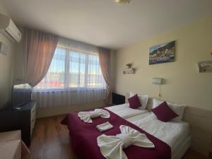 A bed or beds in a room at SUMMER BREEZE 406 Studio Sunny Beach