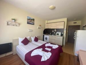 A bed or beds in a room at SUMMER BREEZE 406 Studio Sunny Beach