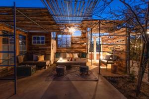 a living room with a couch and a table at Quiet Compound 5Min to Park Pool and Spa 5Acres in Joshua Tree