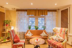 a living room with two chairs and a table at Hotel Weiler in Oberwesel