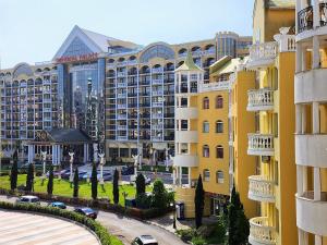 a view of a building with cars parked in a parking lot at Синьо лято /Blue summer in Sunny Beach