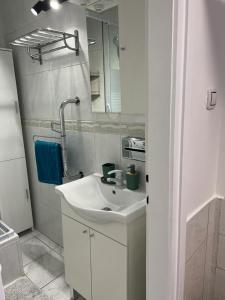 a white bathroom with a sink and a mirror at Apartman Lara in Zagreb +33 photos